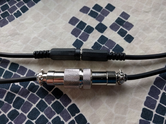 The thin barrel and the GX12-2 connectors, connected, side by side.